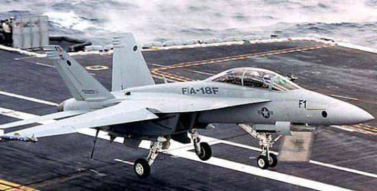 F-18F fighter landing aboard an aircraft carrier