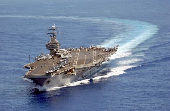 Aircraft carrier turning into the wind to begin air operations