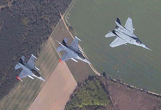 Fourth generation fighters:  F-16s in formation with a MiG-29
